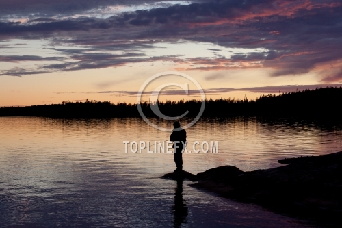 Fisherman silhouette on the beach at colorful sunset 05
