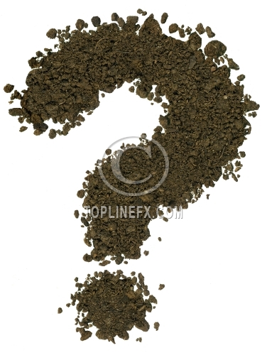 Letter made of brown soil on white background. Question mark